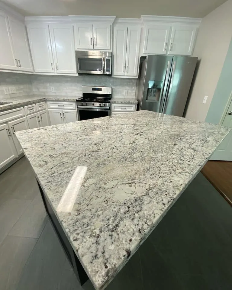 Granite kitchen island and custom cabinetry from a kitchen remodel in Cleveland, TX